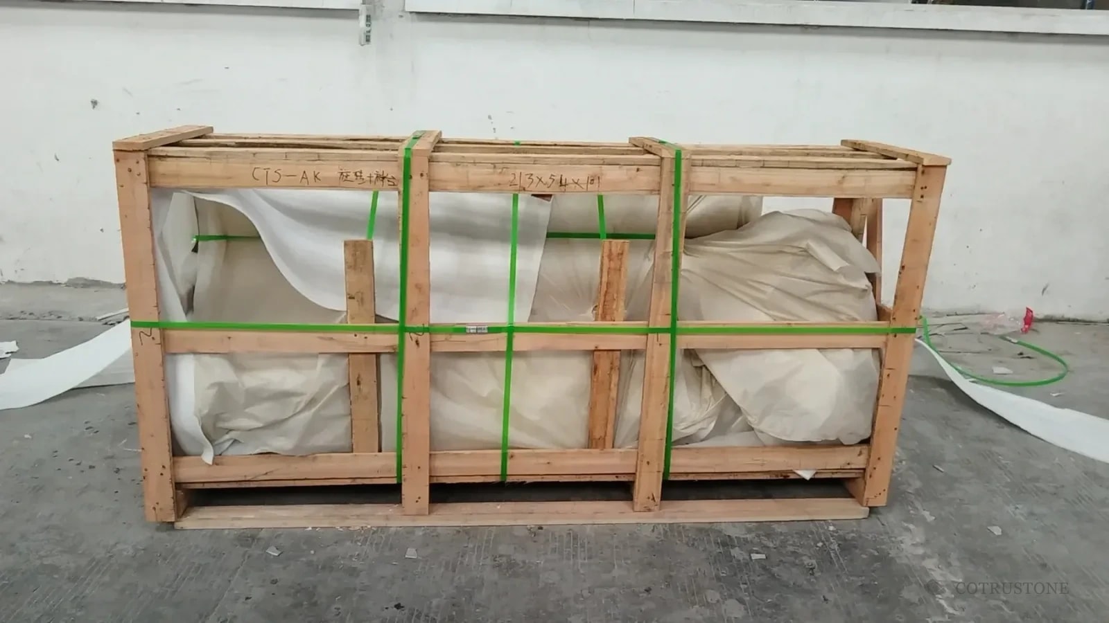 Protected stair components secured inside the marked AK wooden crate