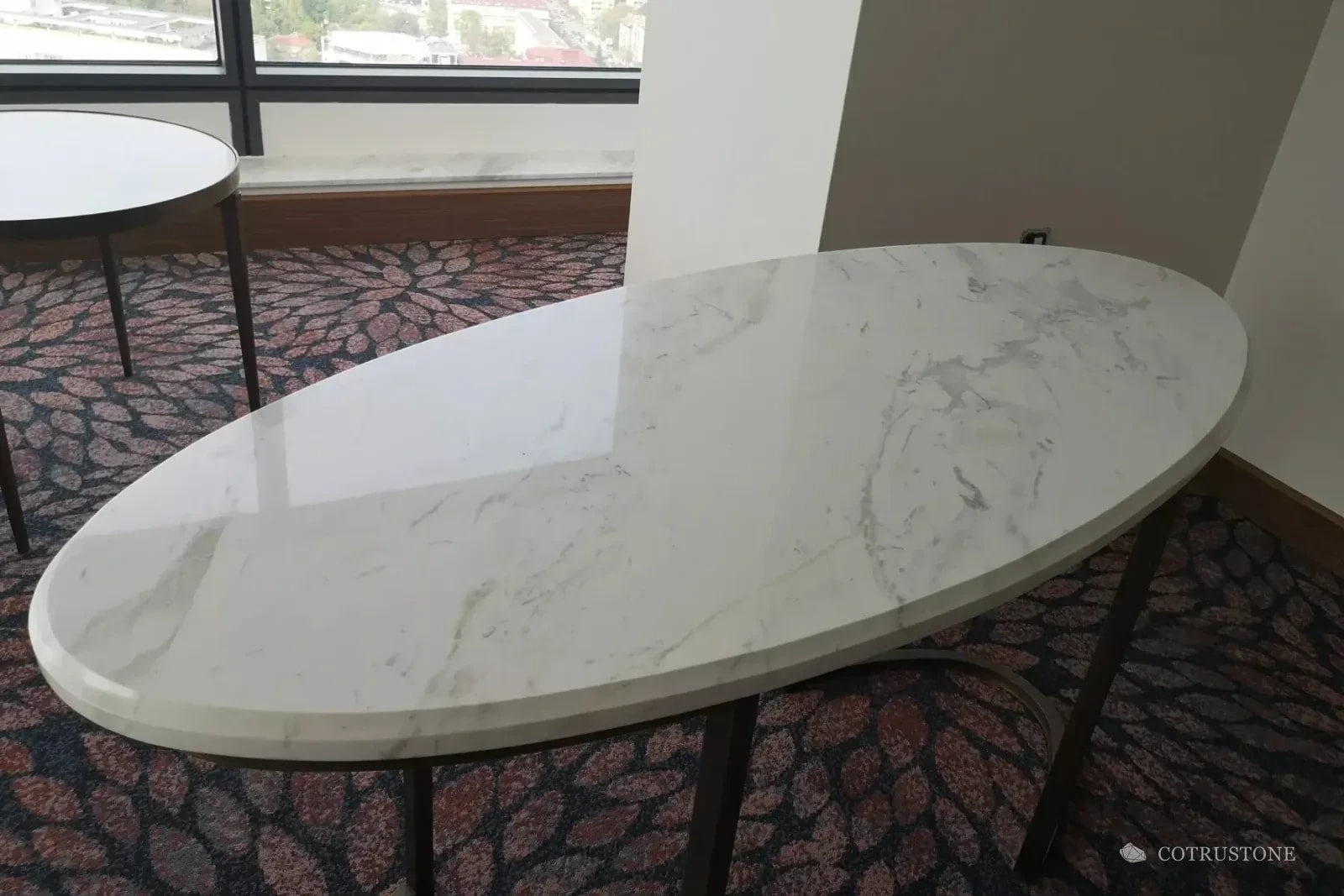 White marble oval furniture top and window board in a Millennium Hotel guestroom