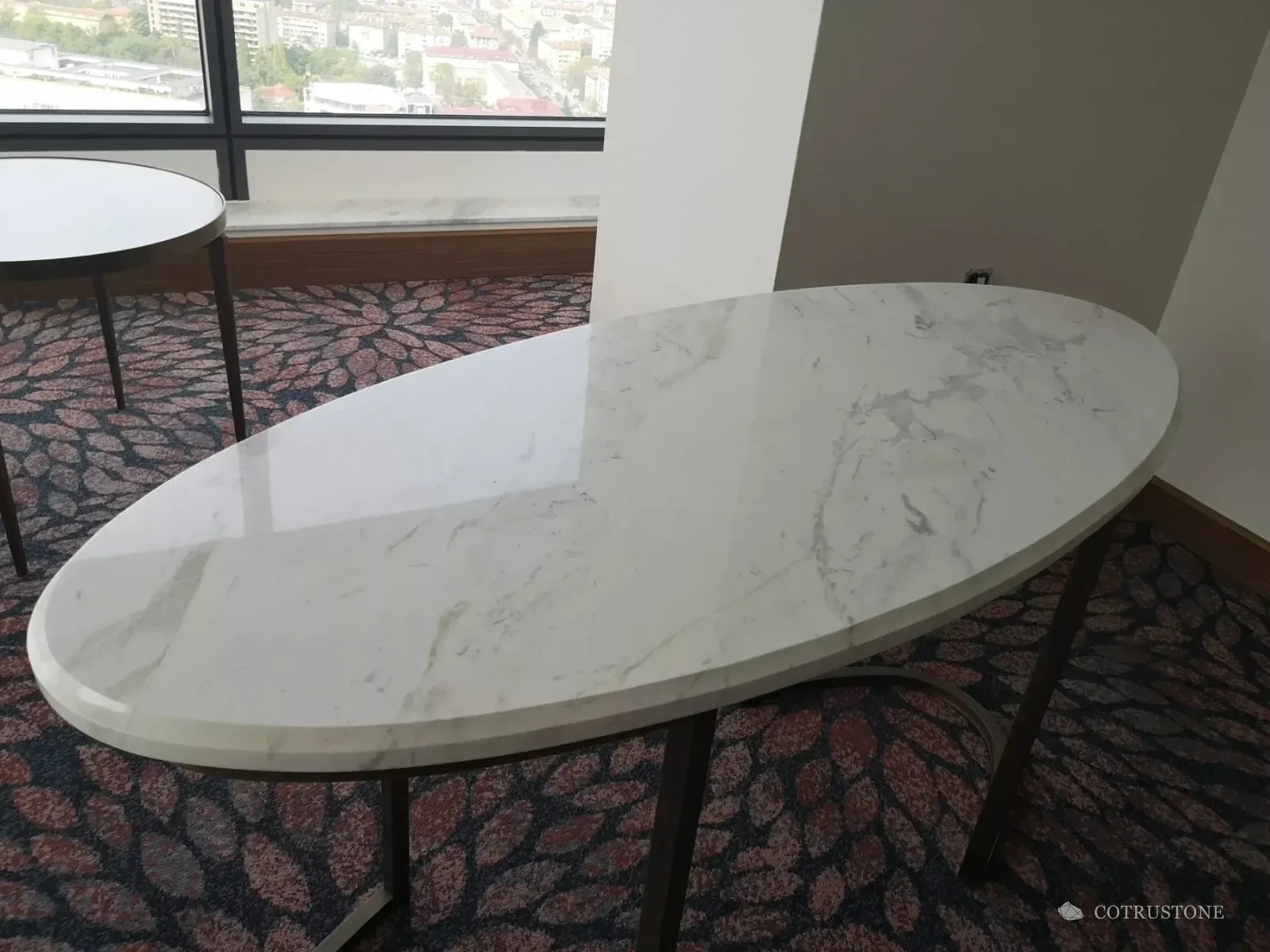 White marble oval furniture top and window board in a Millennium Hotel guestroom