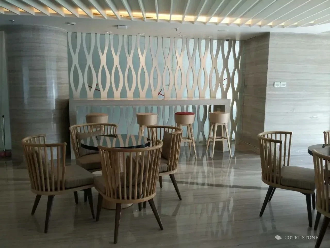 Grey stone flooring and column cladding in a hotel lounge