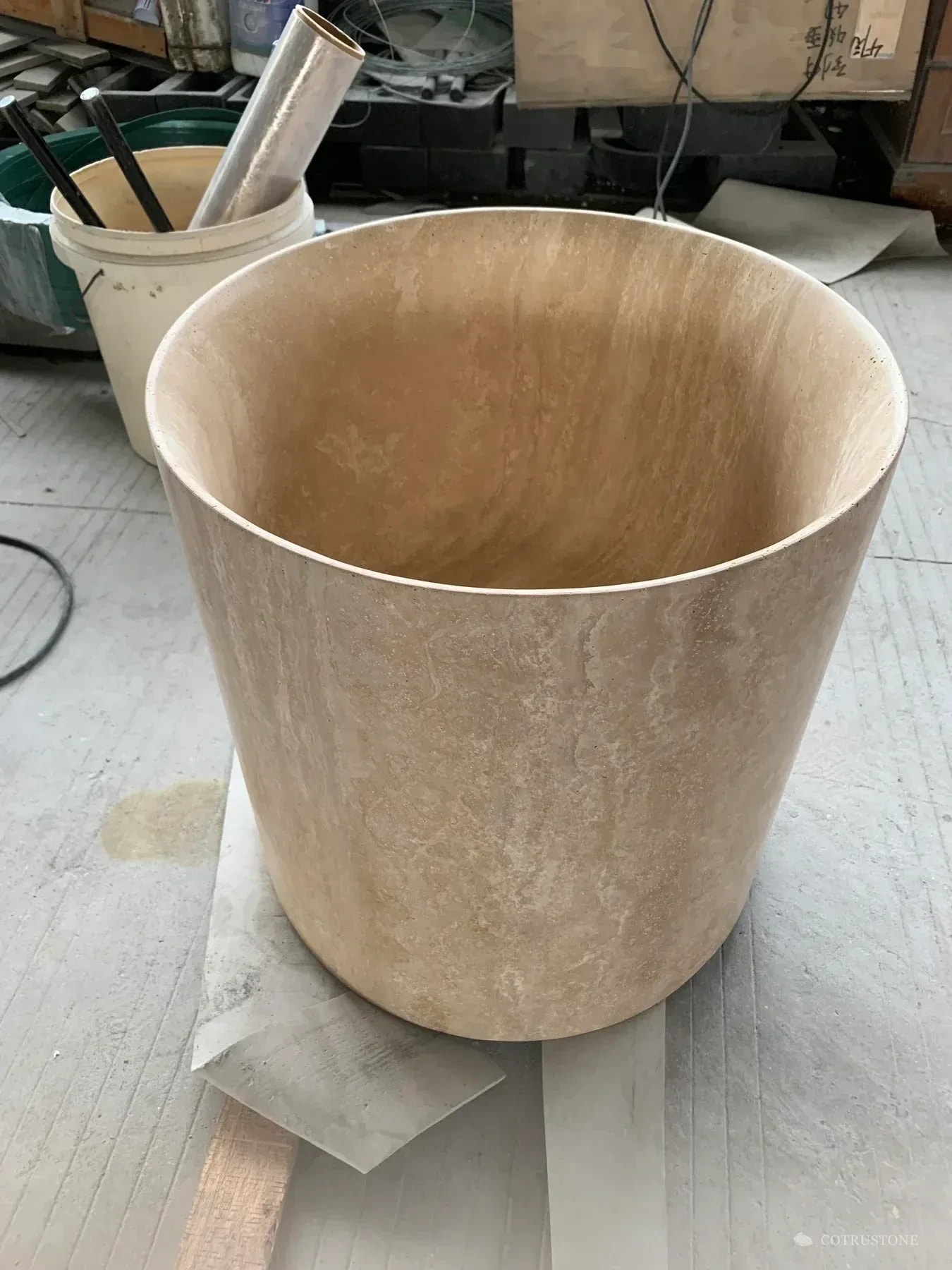 Warm beige stone pedestal basin photographed before dispatch