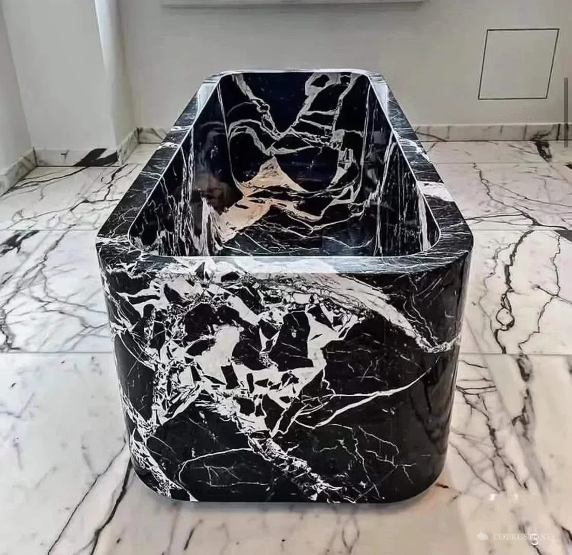 Front view of a black and white stone bathtub showing the bowl and rounded rim