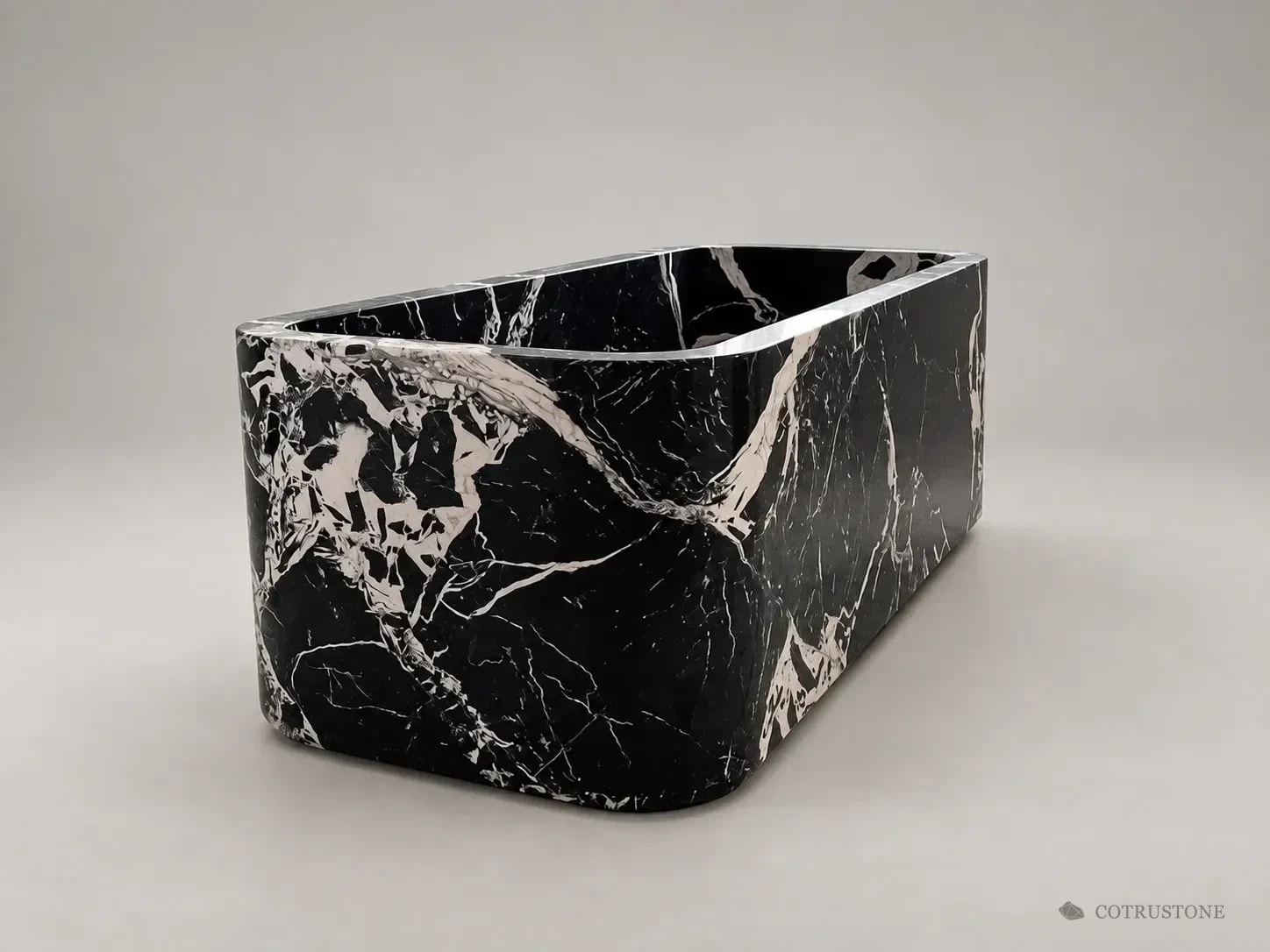 Black and white natural stone bathtub in a neutral studio presentation