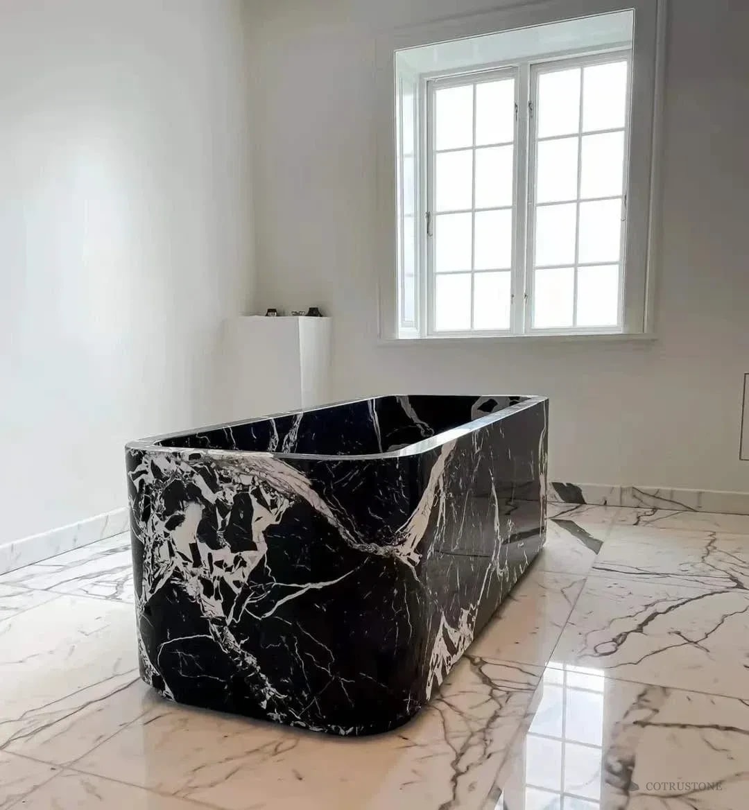Sculptural black and white stone bathtub showing its side profile