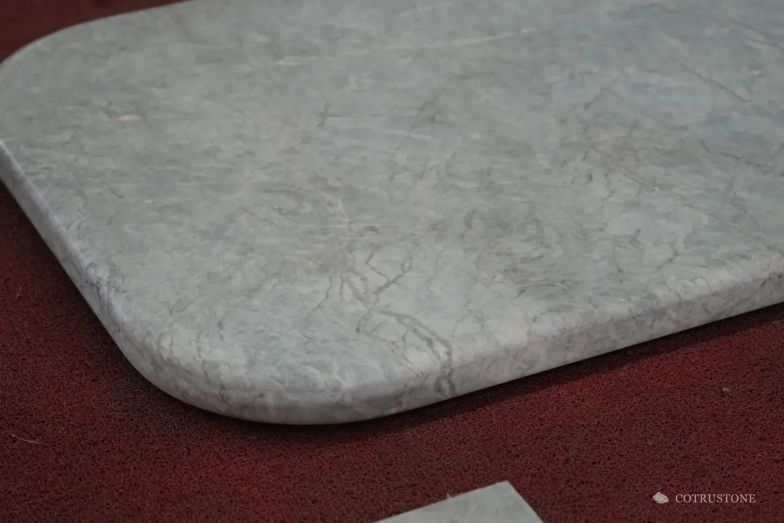 Rounded stone countertop corner showing the finished edge and surface