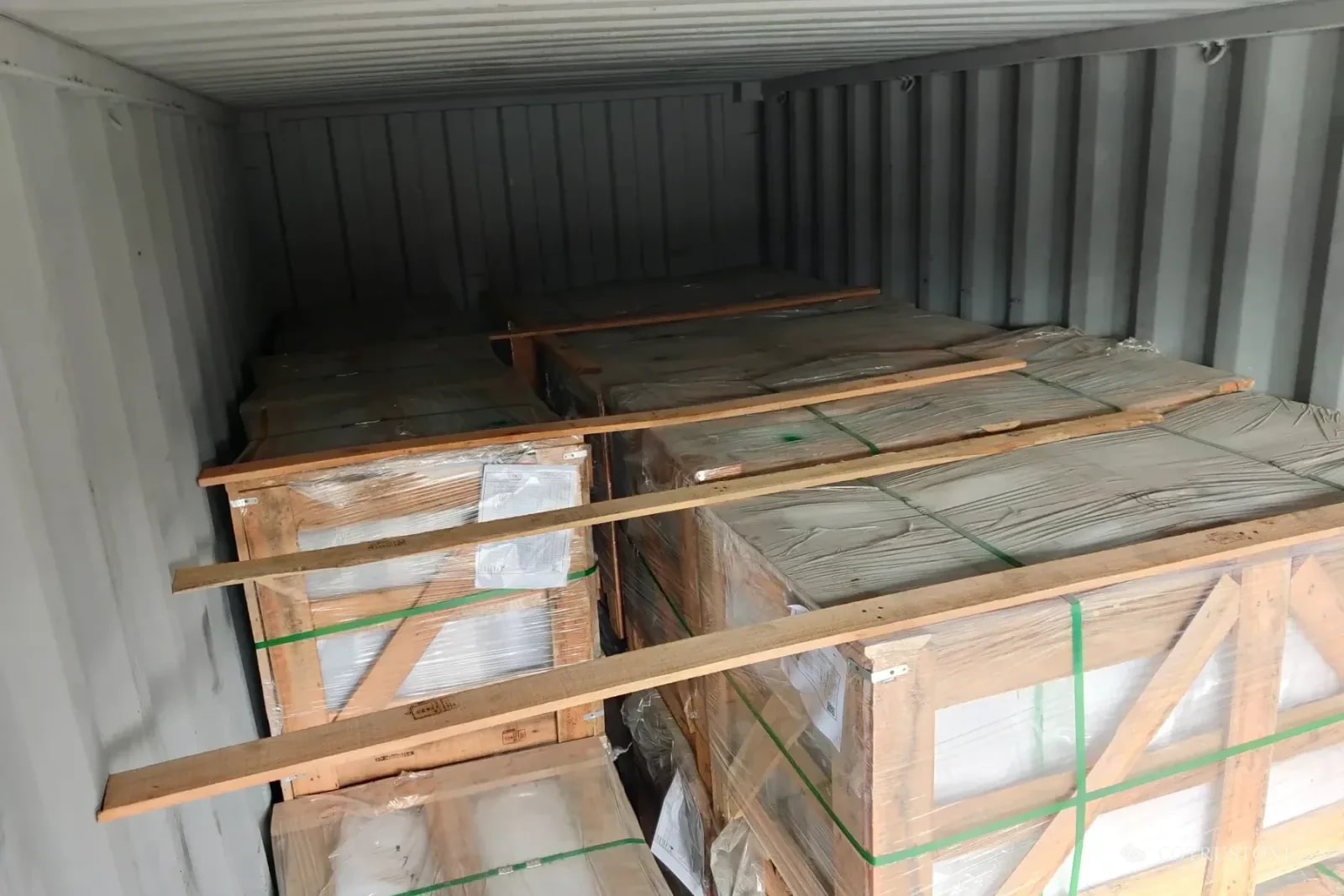 Piedra embalada con refuerzos de madera dentro de un contenedor