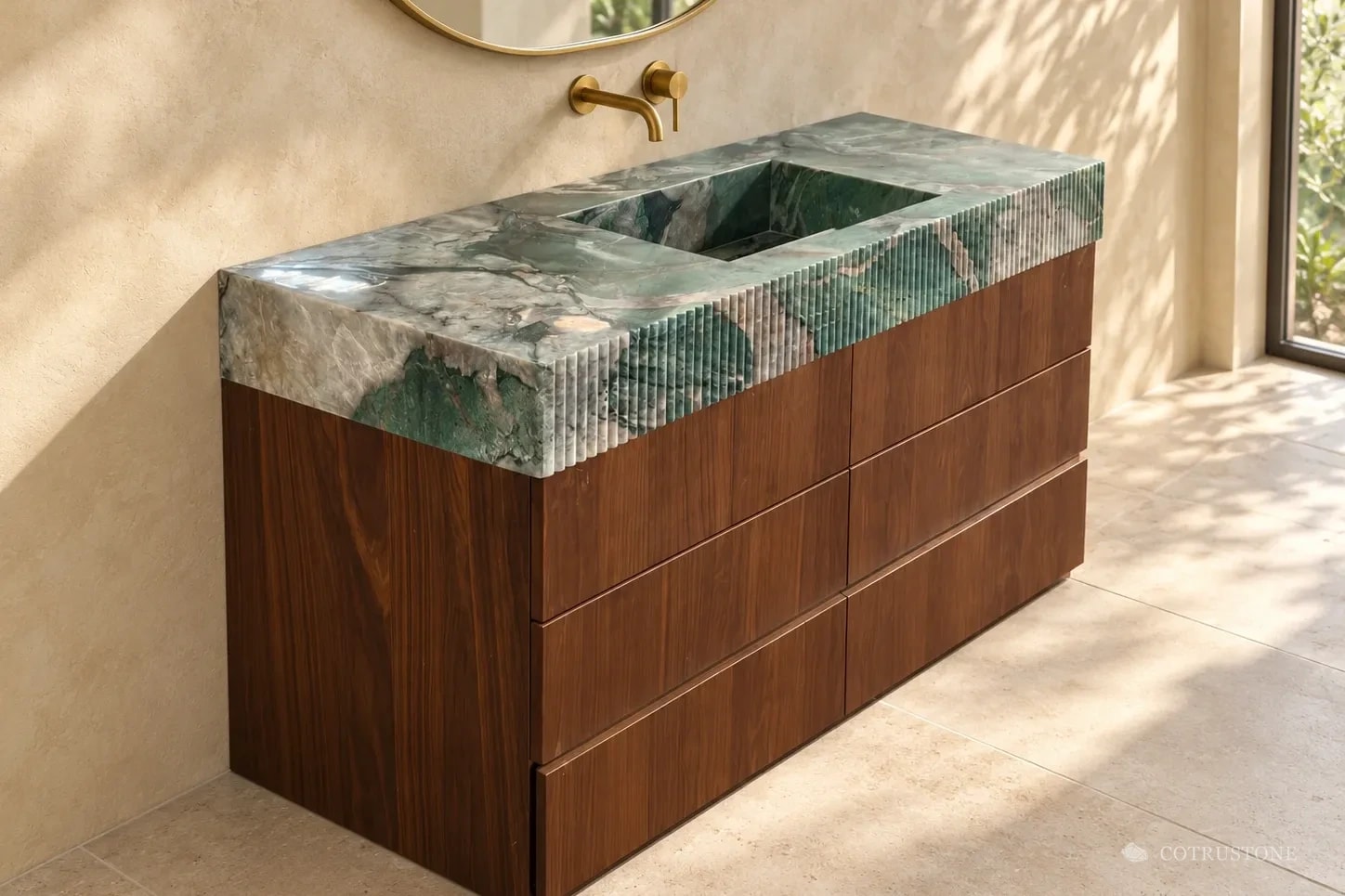 Green veined stone vanity top with a fluted edge and integrated basin on a six-drawer walnut cabinet