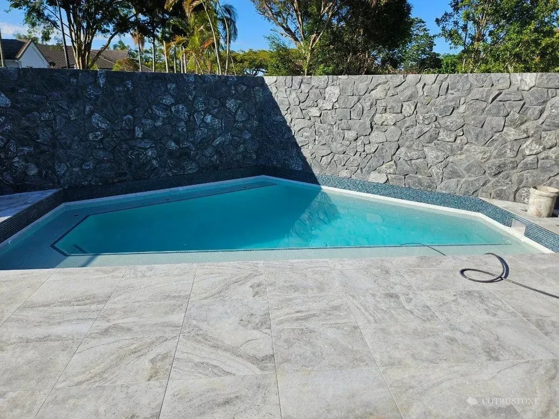 Stone walling and paving in a poolside setting