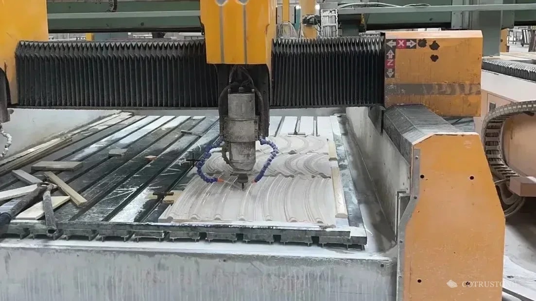 Machining head and curved stone relief on the original workshop machine bed