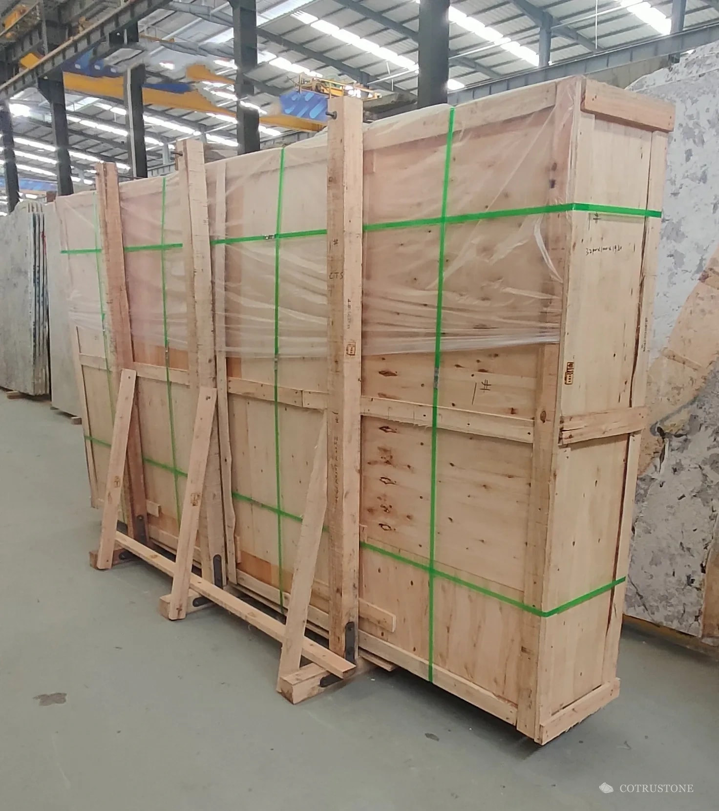 Enclosed plywood slab crate with timber bracing, base supports and green straps