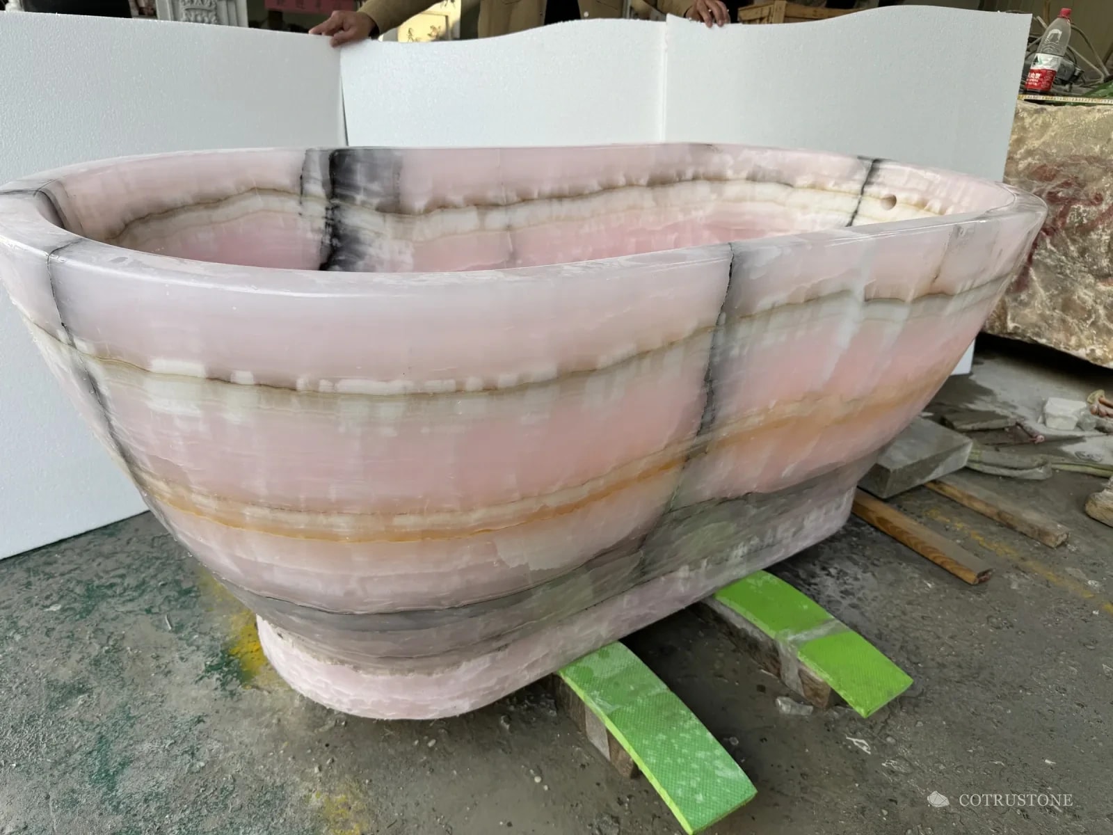 A pink onyx bathtub in the workshop before finishing