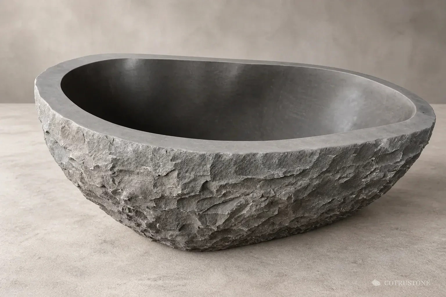 Oval stone bath with a rough exterior