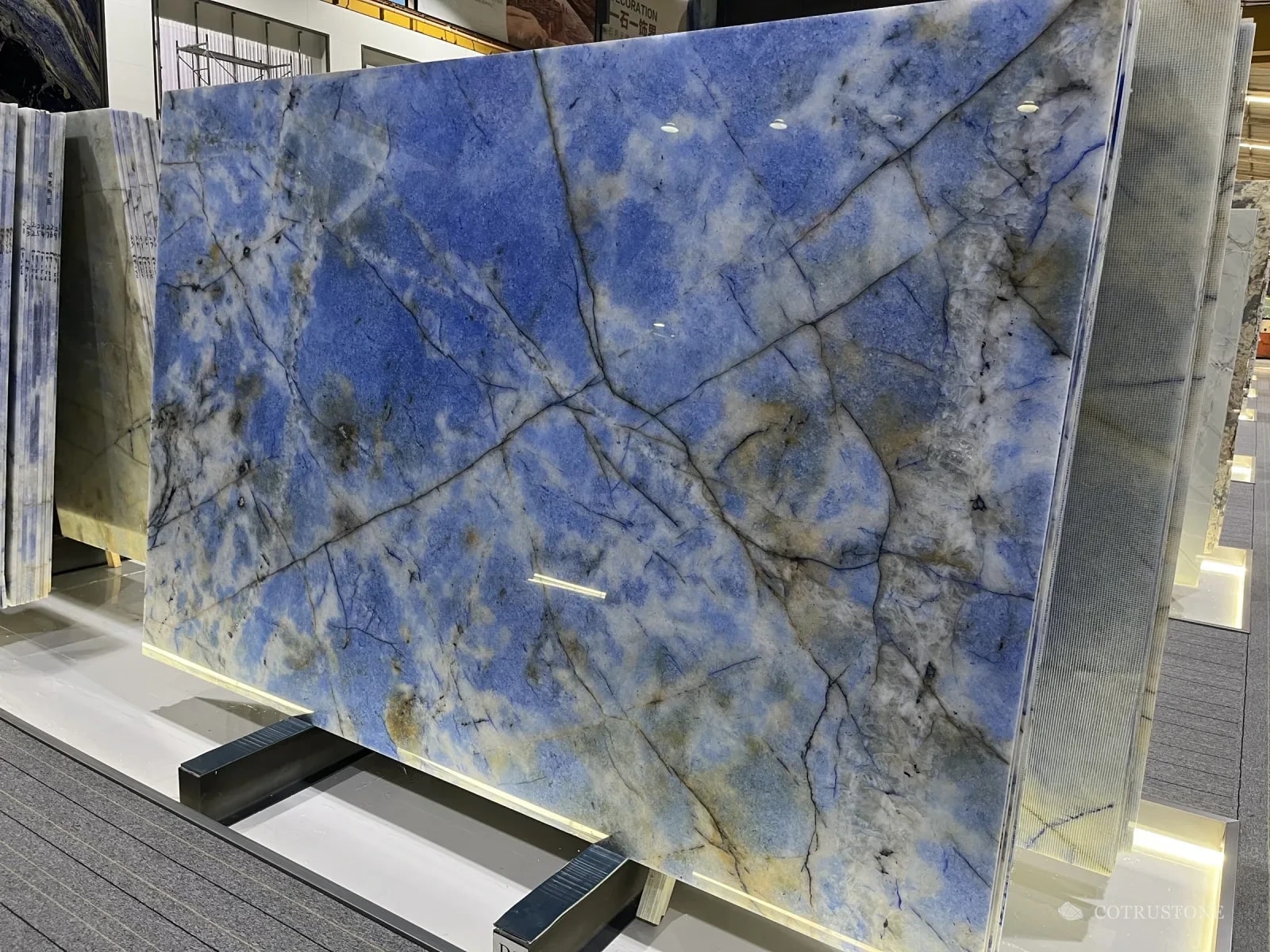 A slab of Louise Blue quartzite, deep blue with white and dark veins