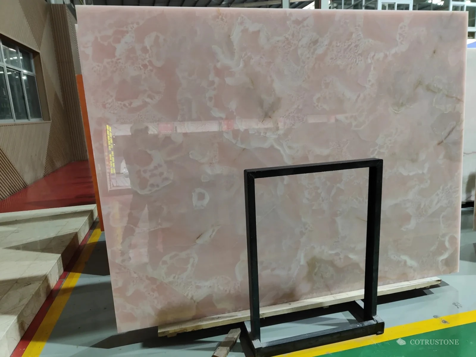 A slab of pink onyx on a stand