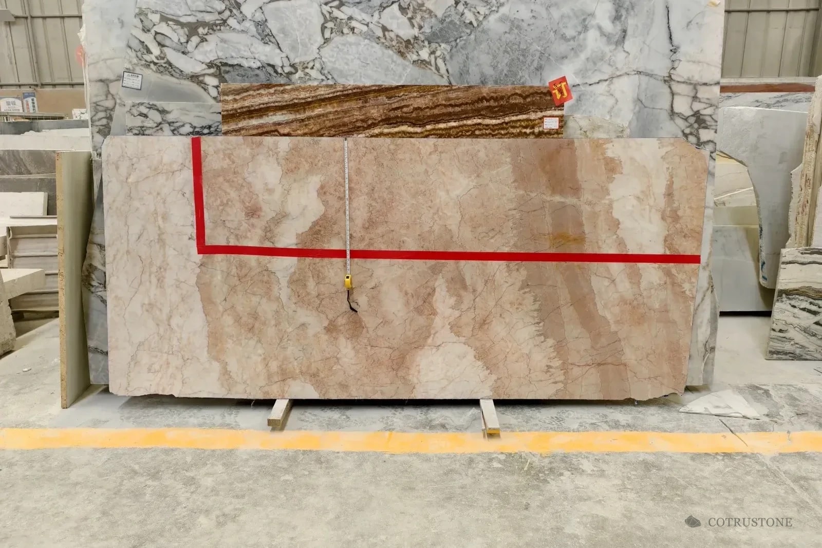 Stone slabs with a marked selection area and measuring tape