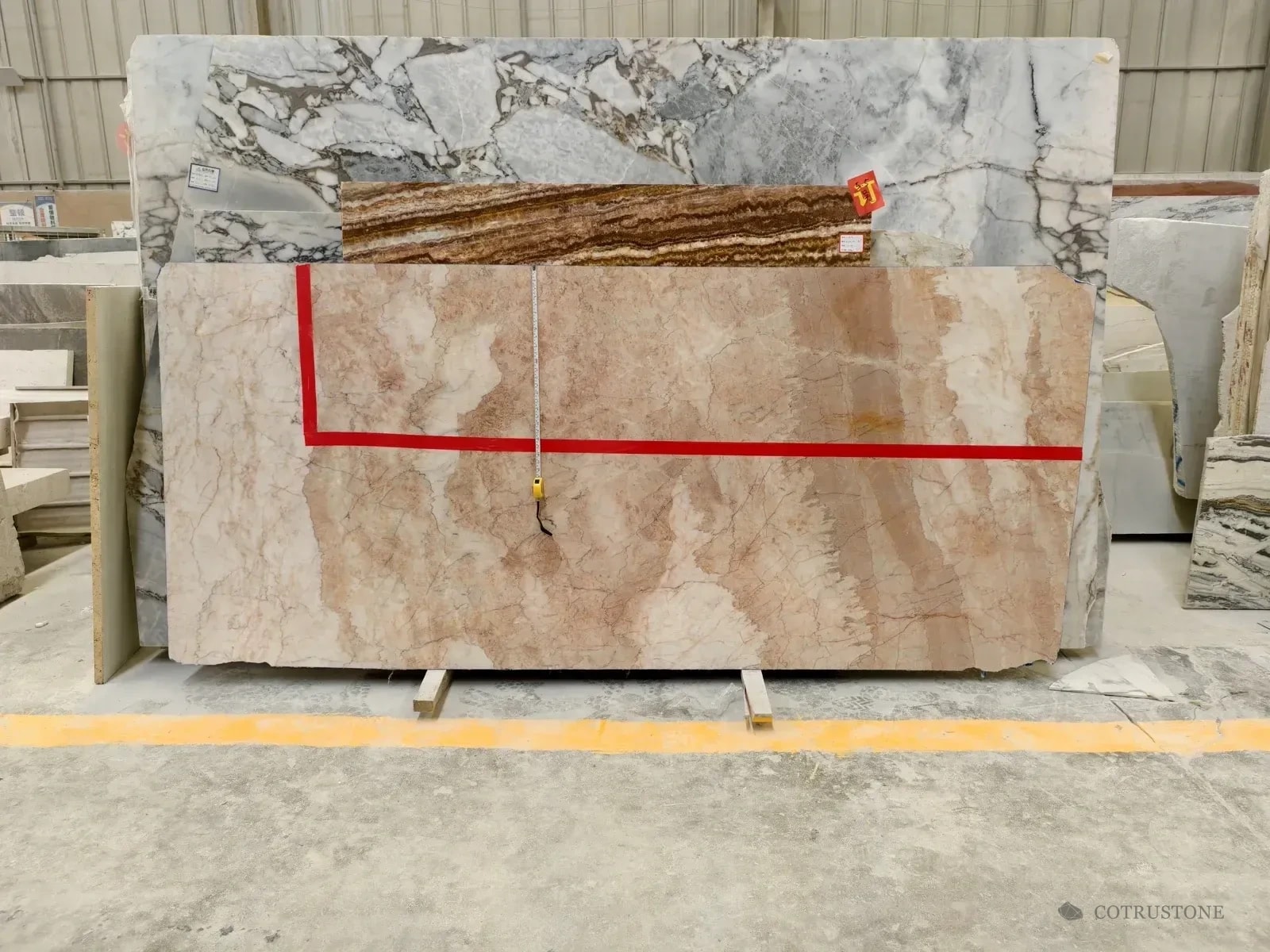 Stone slabs with a marked selection area and measuring tape