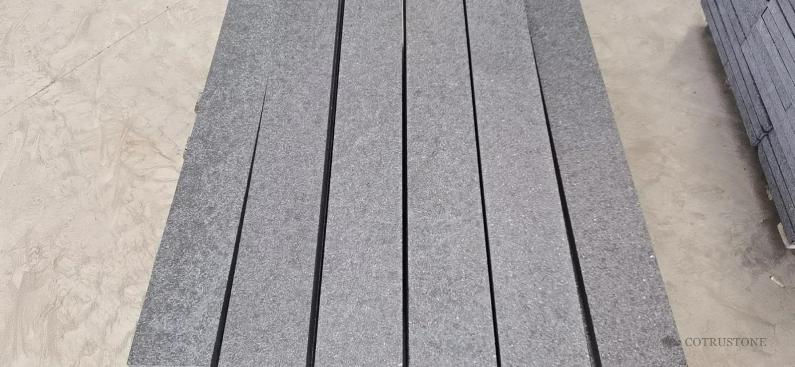 Grey stone stair components aligned in a batch