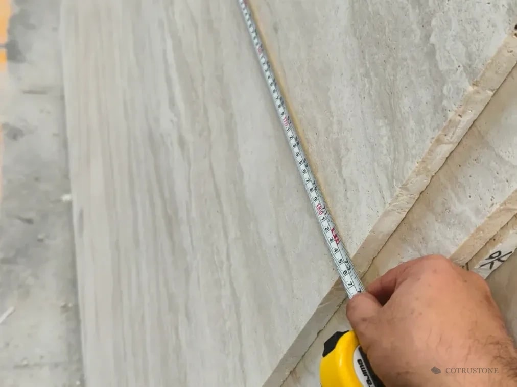 Tape measurement along the edge of a Taj Mahal sink component