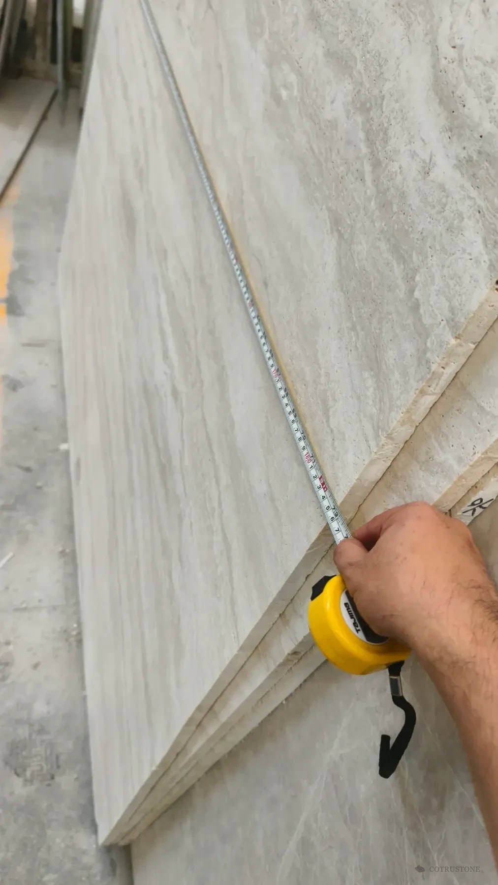 Tape measurement along the edge of a Taj Mahal sink component