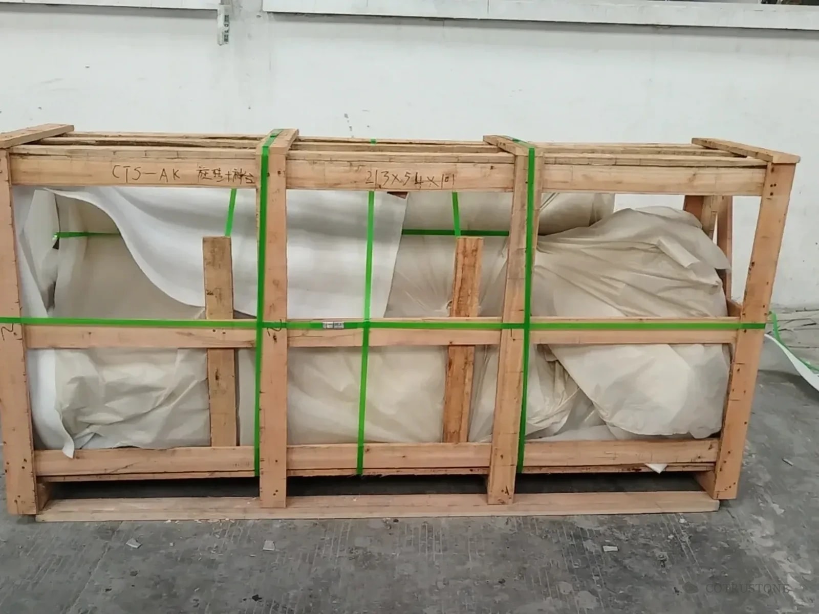 Protected stair components secured inside the marked AK wooden crate