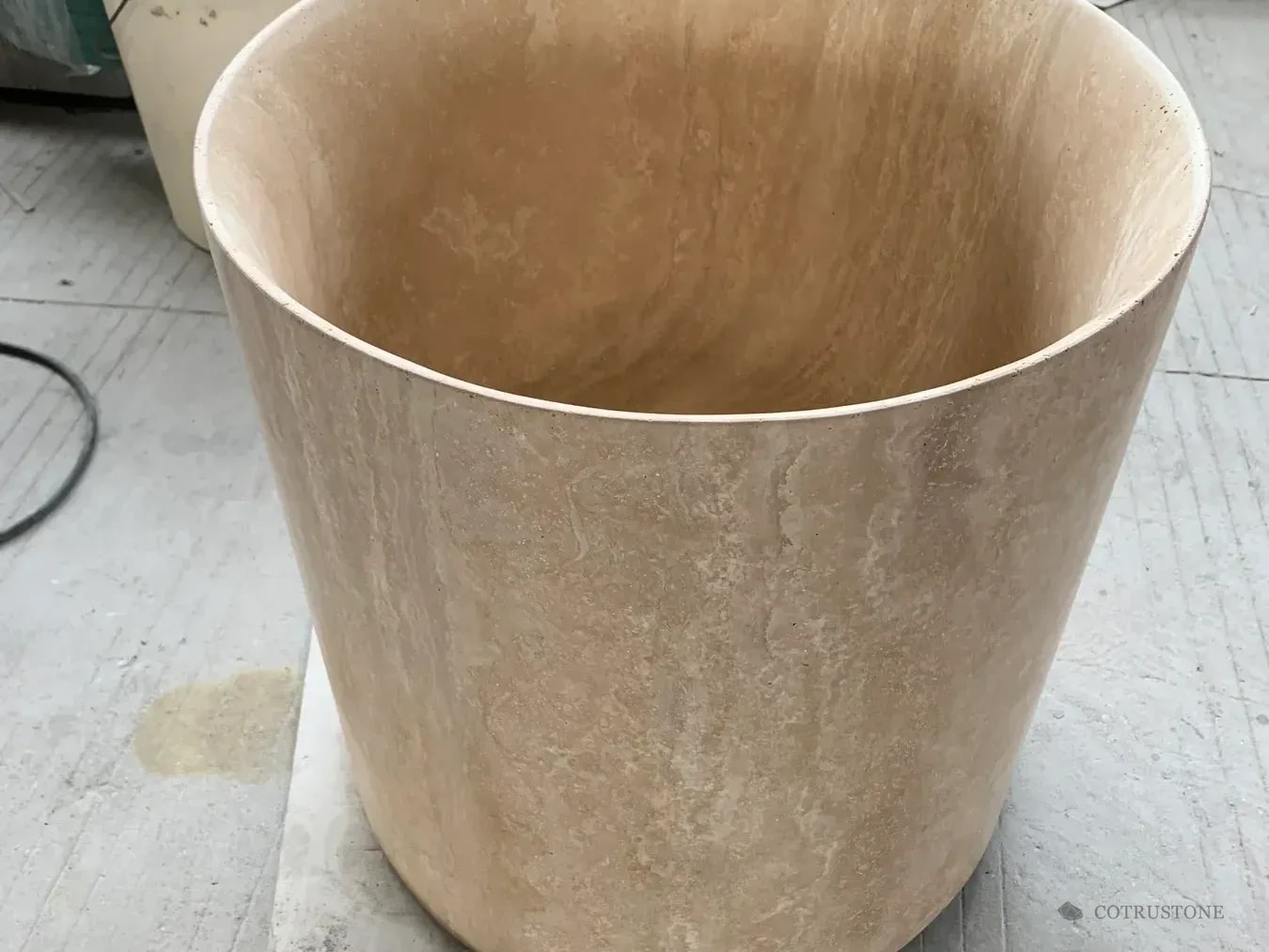 Warm beige stone pedestal basin photographed before dispatch