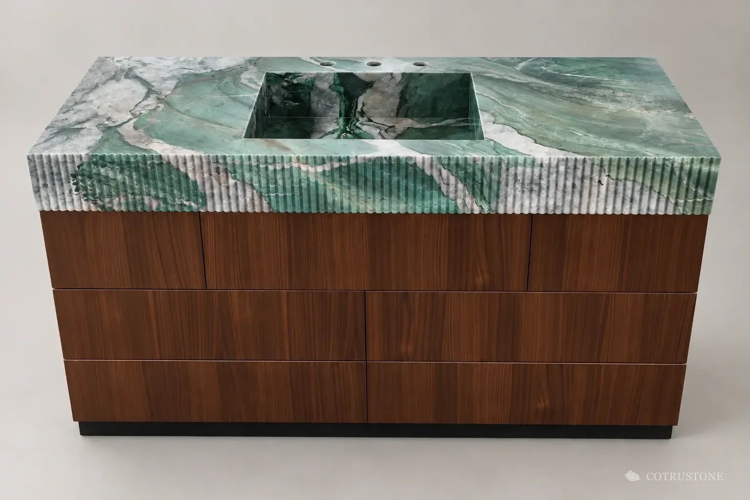 Green veined stone integrated basin with a reeded front and dark wood cabinetry on a neutral background