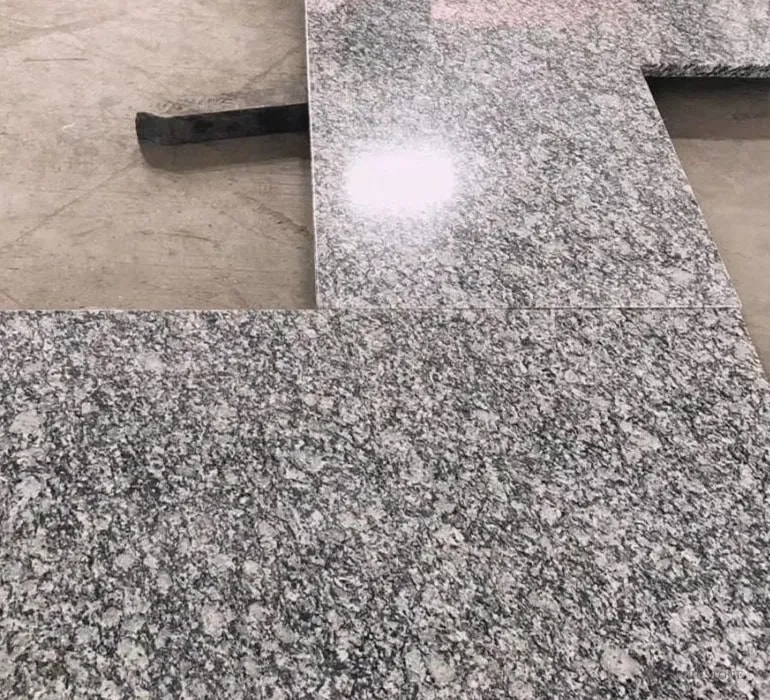 Spray White Granite Countertop — grey and white granular pattern