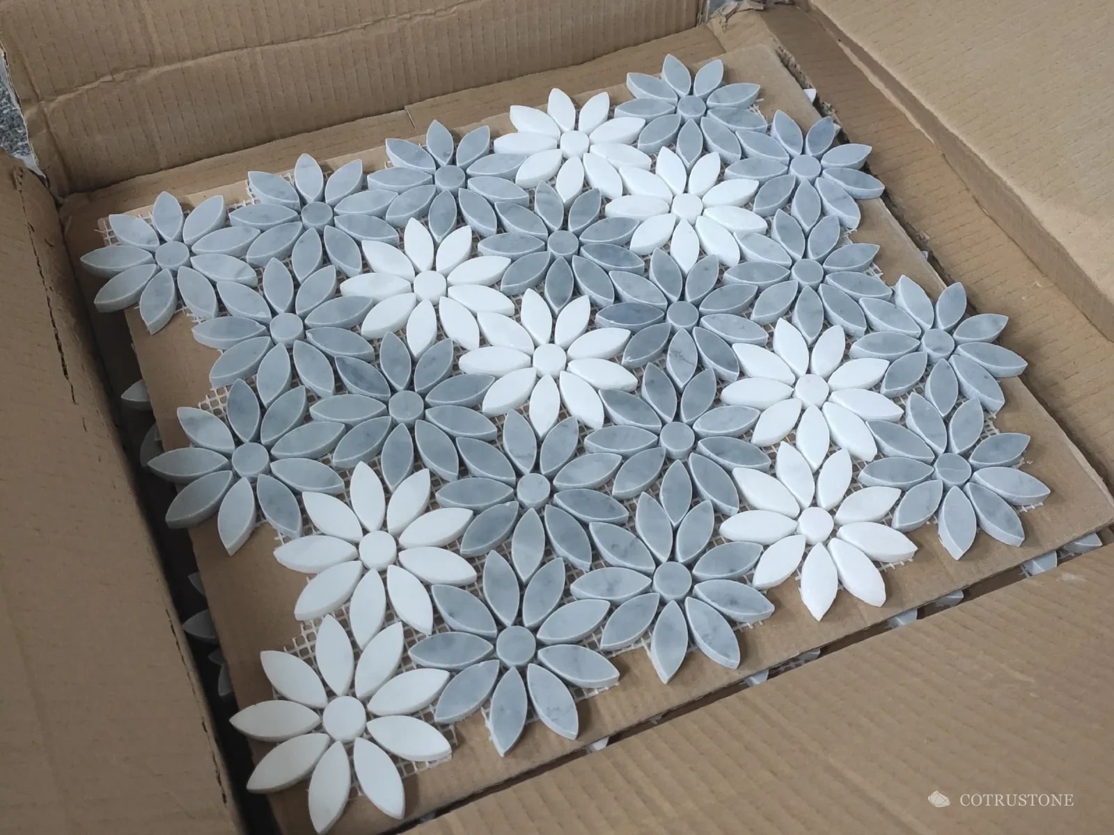 Daisy mosaic sheets packed flat in a carton