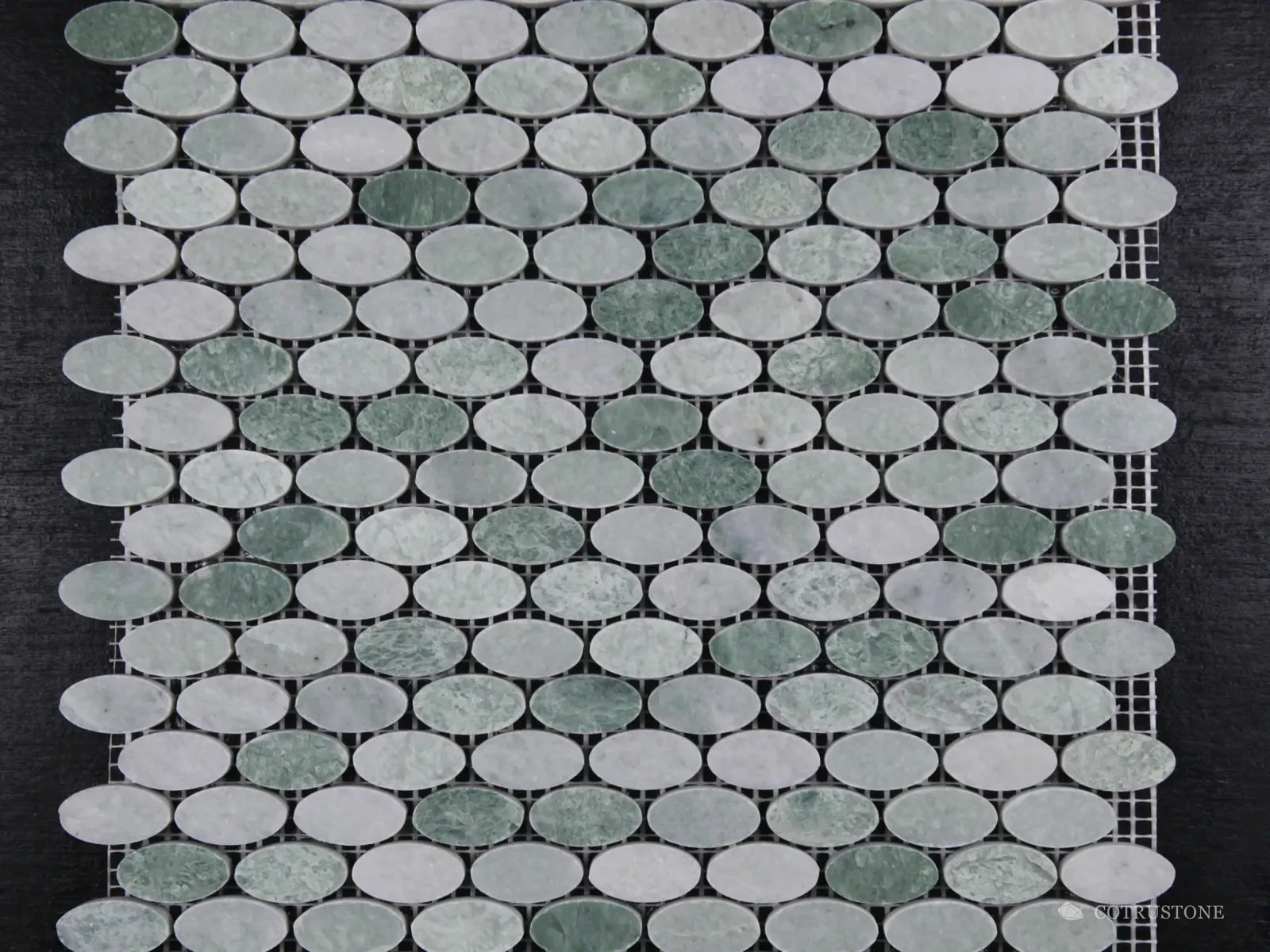 Oval mosaic sheet mixing green and pale grey stone