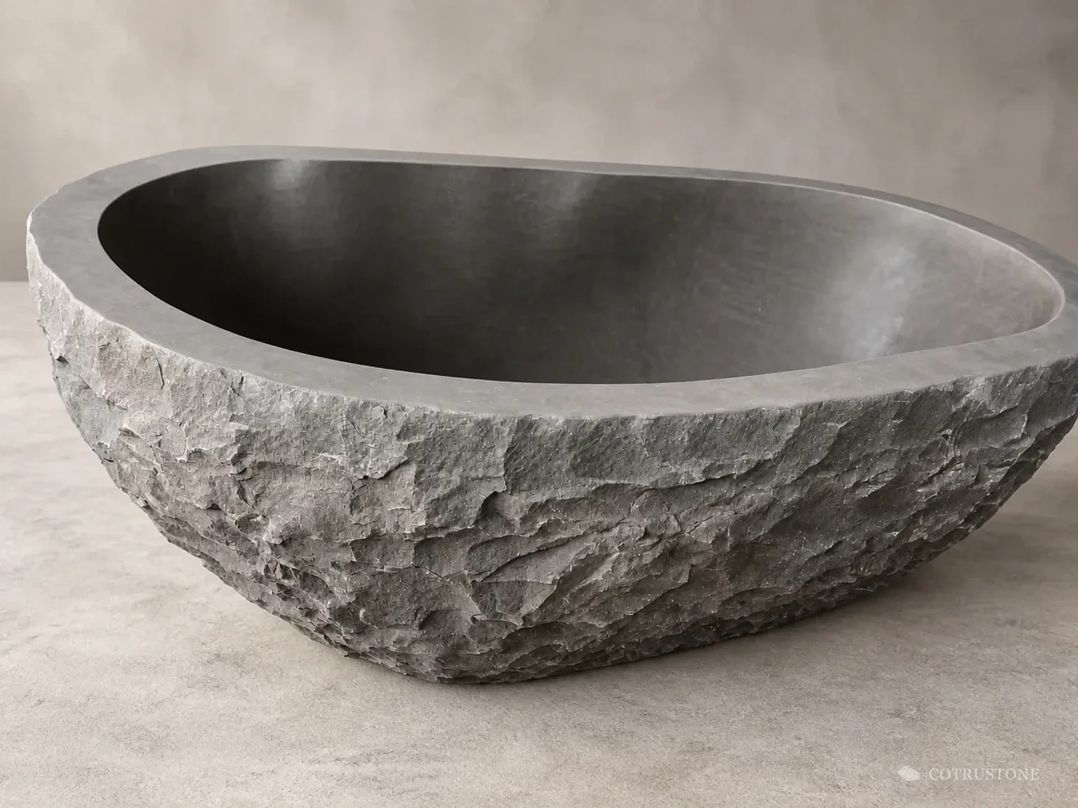 Oval stone bath with a rough exterior