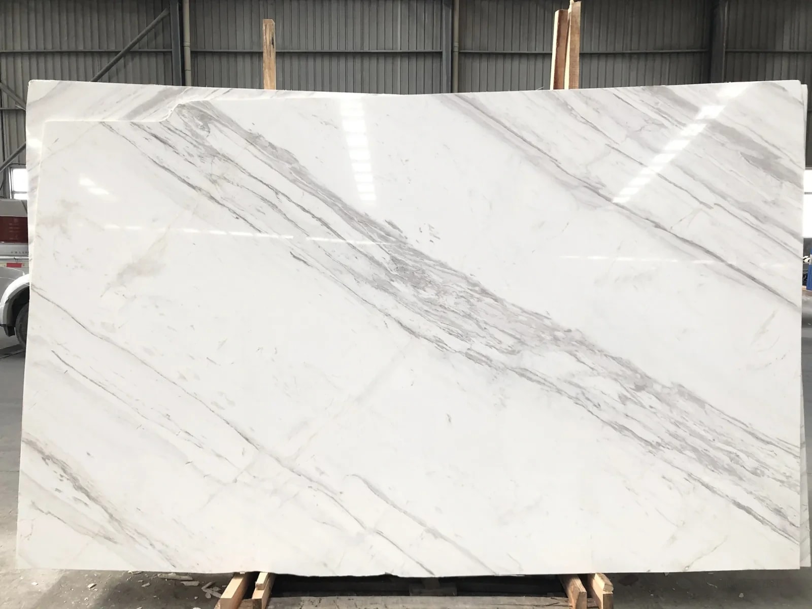 A full slab of Volakas marble, white with soft grey diagonal veins