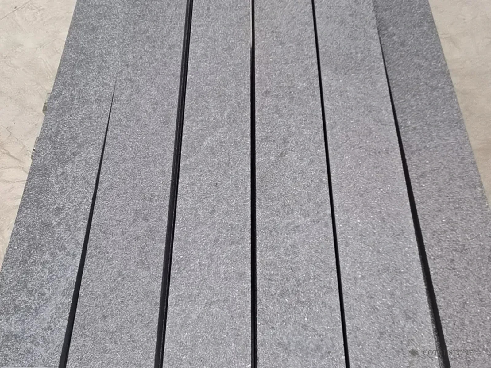 Grey stone stair components aligned in a batch