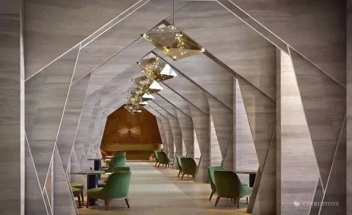 Geometric stone-clad portals with linear veining in an interior space