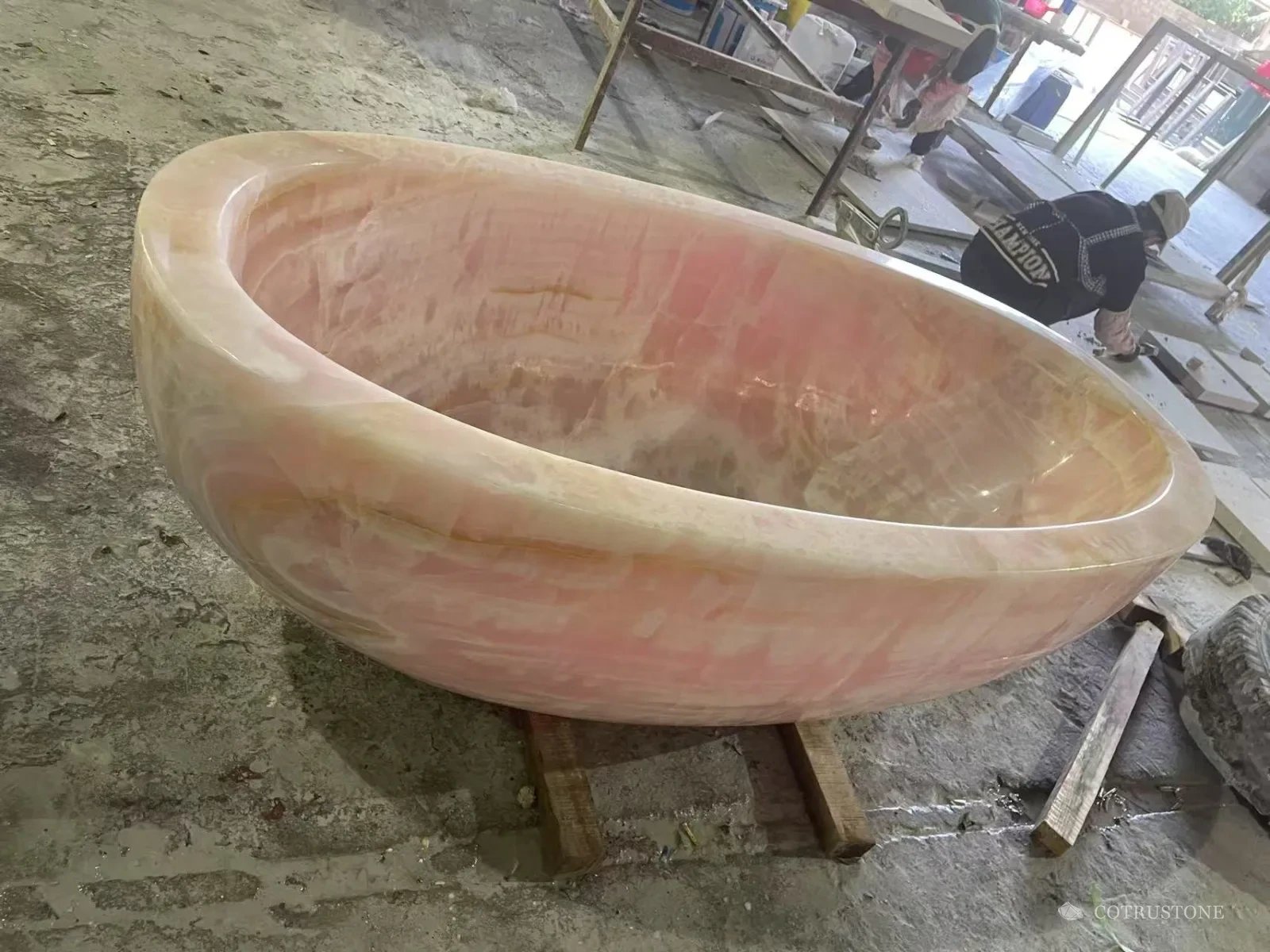 Pink onyx bathtub photographed in the workshop
