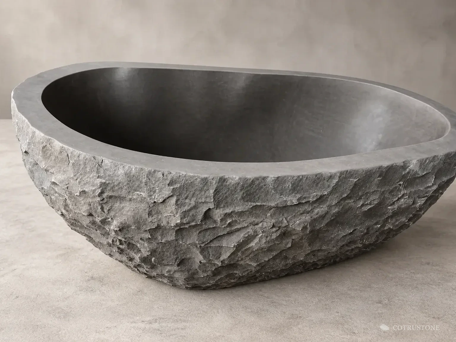 Oval stone bath with a rough exterior